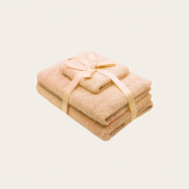Madhome.ro set of three beige cotton towels tied with a ribbon, featuring 500 g/m² density and reinforced edges.