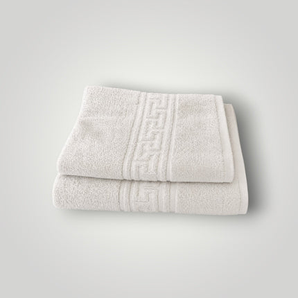 Madhome.ro set of two beige cotton towels with Greek key border design, folded and stacked for bathroom use.