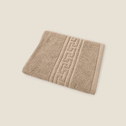 Madhome.ro beige cotton bath towel with a decorative Greek key border pattern and high-density absorbent texture.