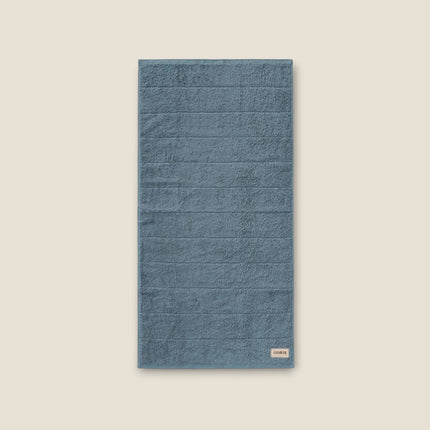 Madhome.ro blue cotton bath towel with a soft, dense texture and elegant stitched detailing.