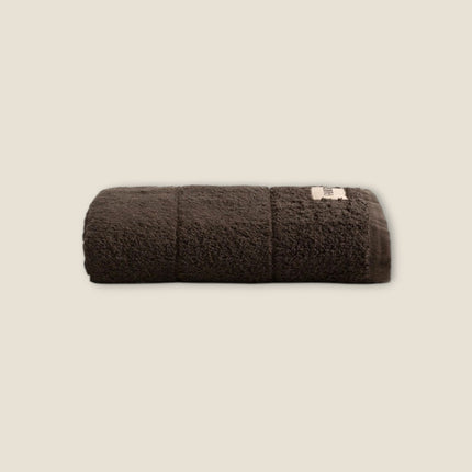 Madhome.ro dark brown cotton bath towel with a plush, absorbent texture and reinforced hem detail.