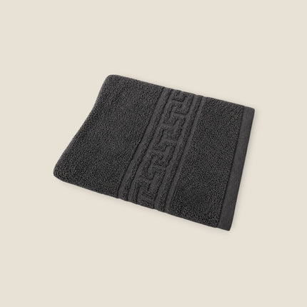 Madhome.ro grey cotton towel with a classic Greek key border design, featuring a soft, absorbent 500 g/m² texture.