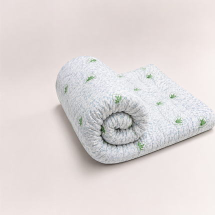 Madhome.ro 5cm memory foam mattress topper rolled up with a white and blue Aloe Vera patterned removable cover
