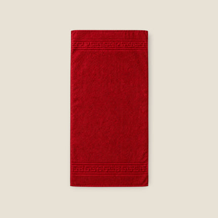 Madhome.ro red cotton towel with a classic Greek border design, featuring a durable 500 g/m² hotel-quality texture.