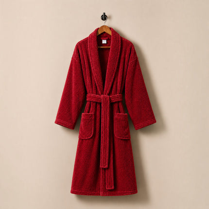 Madhome.ro red cotton velour bathrobe with shawl collar, belt, and pockets, hanging on a wall hook.