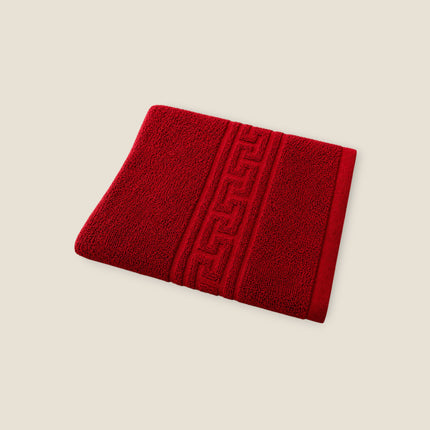 Madhome.ro red cotton towel with a decorative Greek key border, featuring a high-density 500 g/m² absorbent texture.