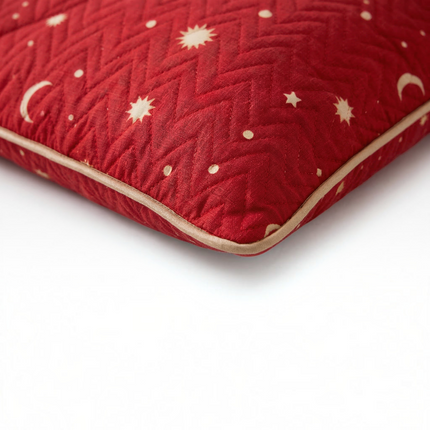 Madhome.ro red quilted pillow with a celestial pattern of stars and moons, featuring beige piping trim.