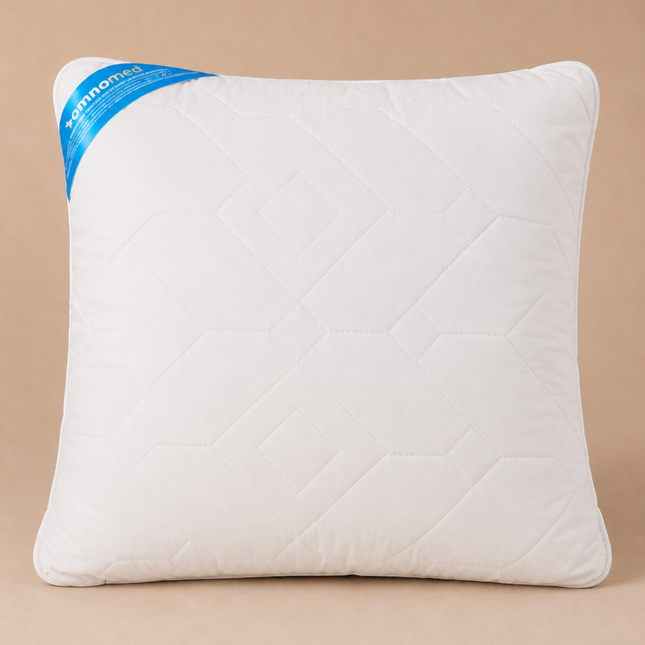 Madhome.ro Somnomed white hypoallergenic pillow with quilted pattern and blue branding label on a beige background