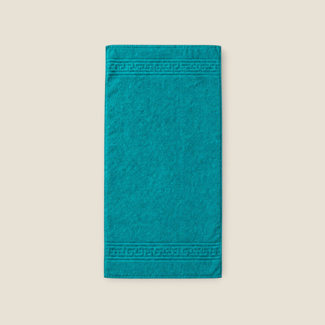 Madhome.ro turquoise cotton towel with a classic Greek key border design and durable double-stitched edges.