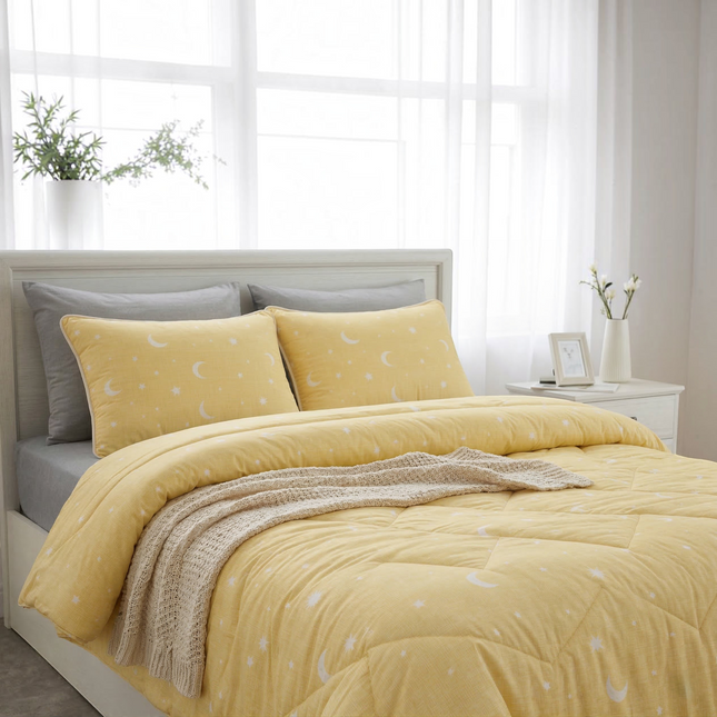 Madhome.ro yellow quilted duvet and two pillowcases set with white moon and star pattern on a bed